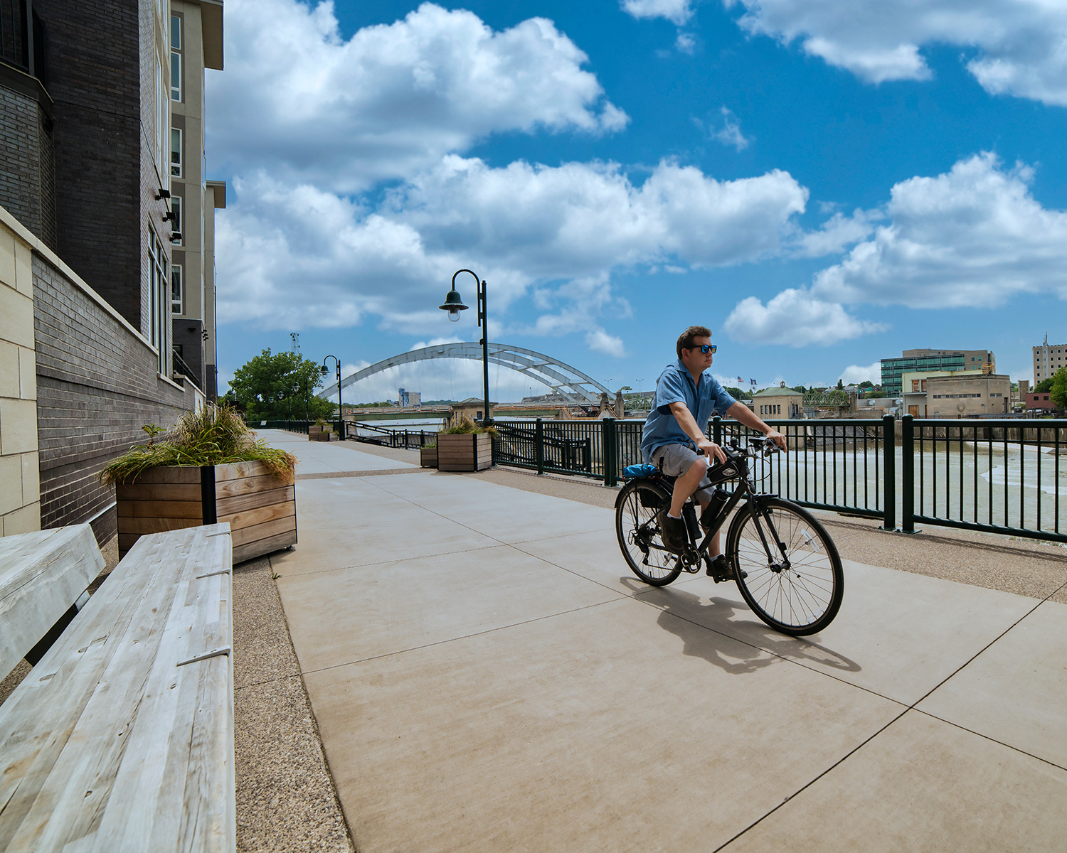 Person riding bike along community path/sidewalk