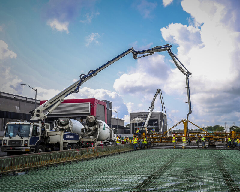 Crew of construction workers working on roadway