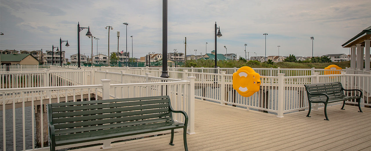 Benches, lights and flotation devices on pier