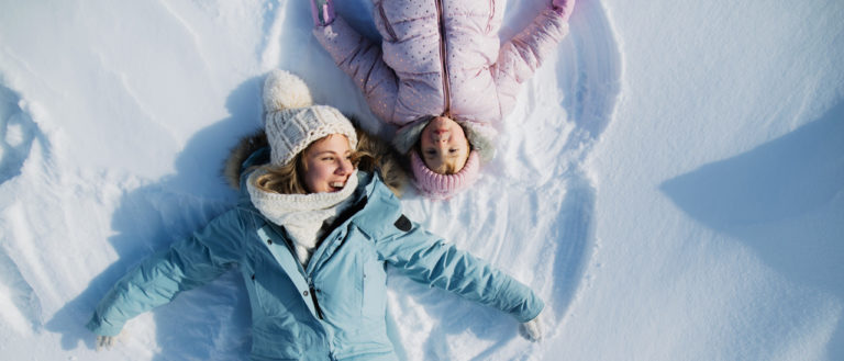 Making snow angels during winter