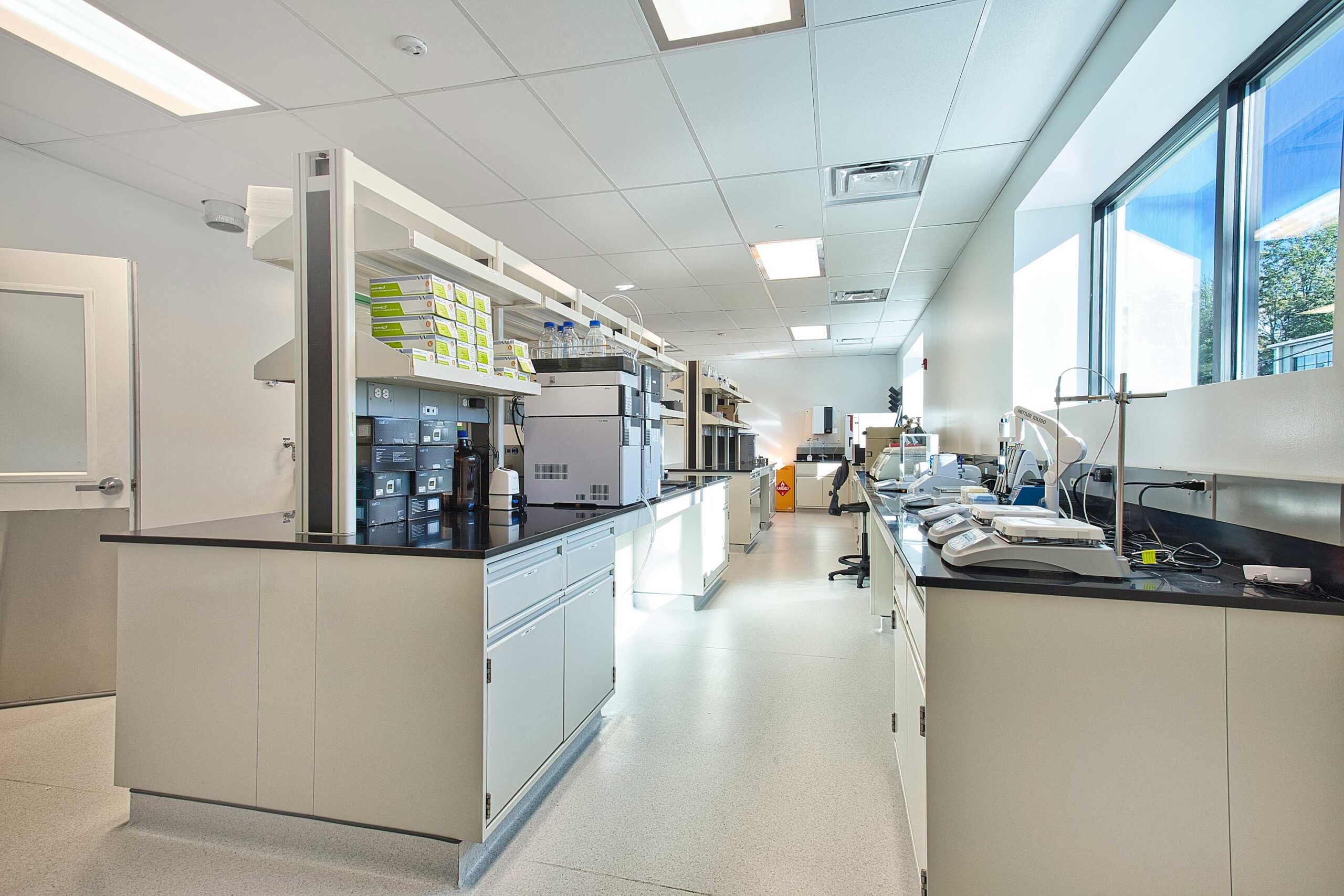 Radiopharmaceutical Production and Office Building room with counter spaces filled with equipment for testing.