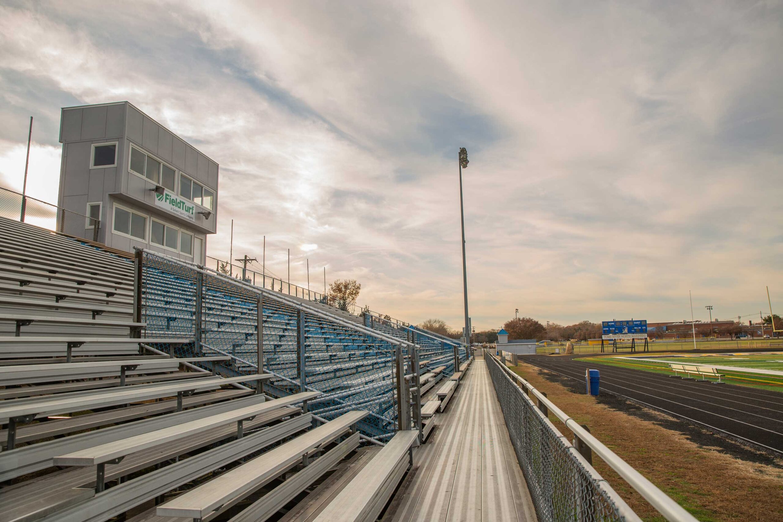 Photo of bleachers and light pole alongside Toms River Intermediate North School track and field.