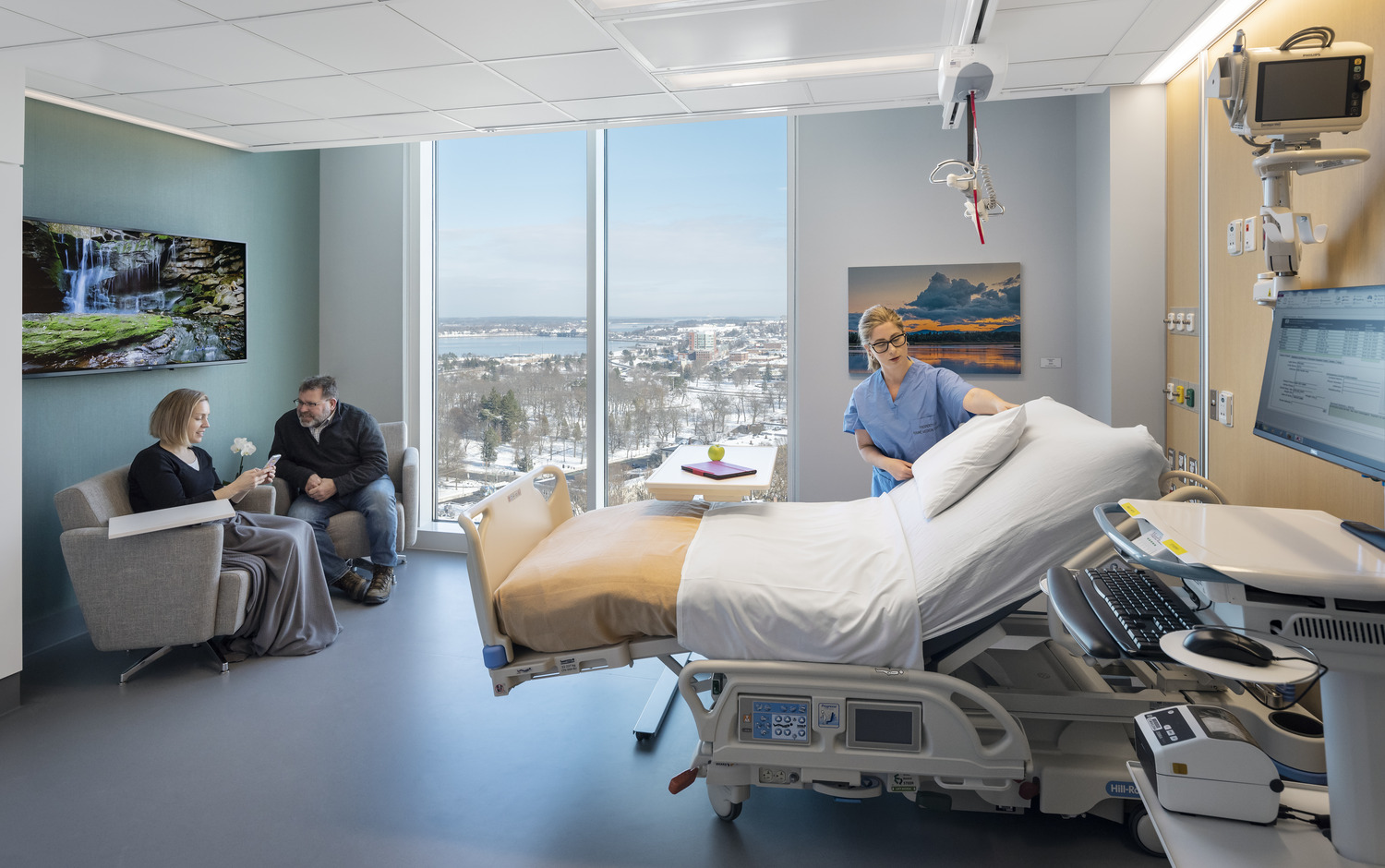 Nurse setting up patient room in hospital.