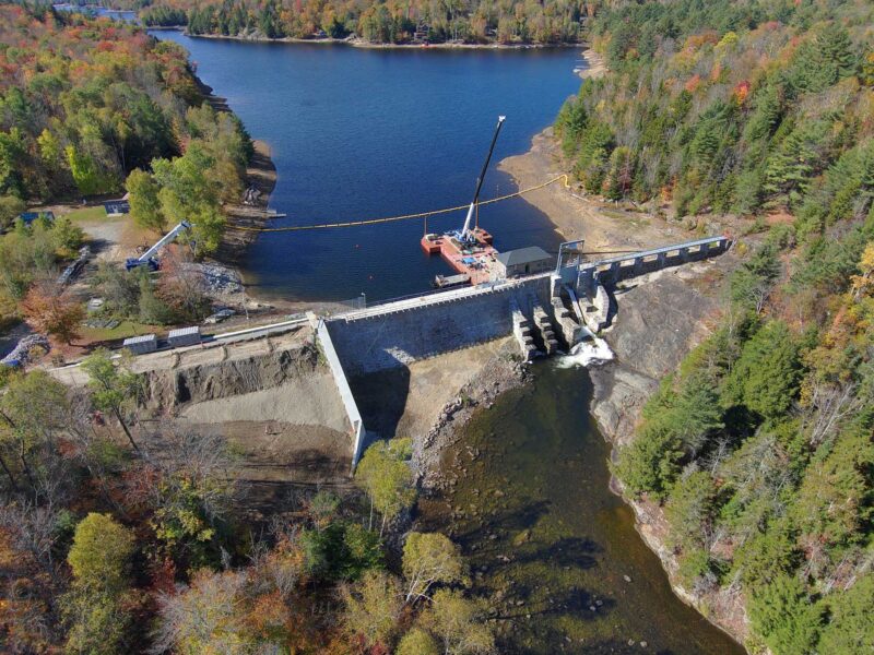 Aerial view of Indian Lake Dam featuring a mass concrete core with a stone masonry exterior and piers.