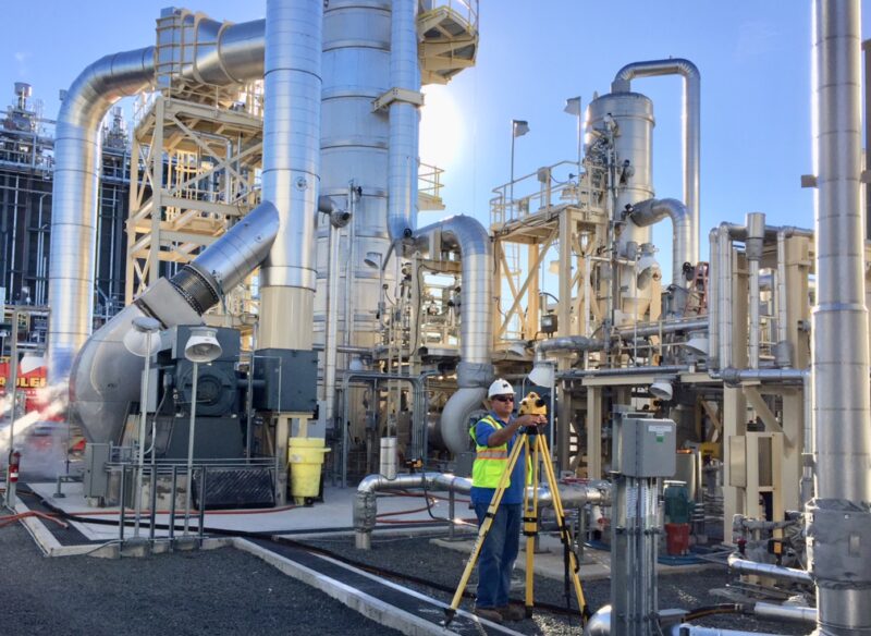 Worker conducting a land survey at the Panda Stonewall Energy Plant.