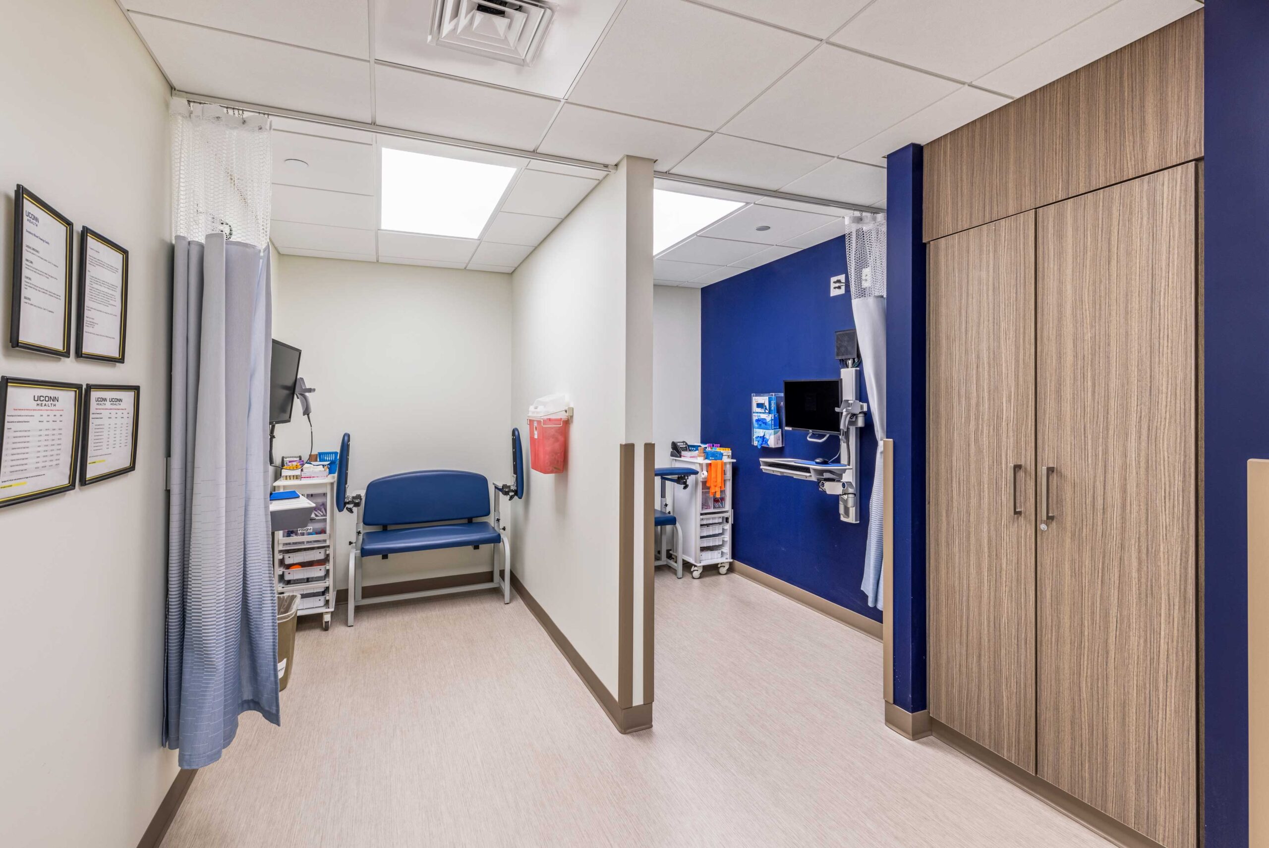 Flexible exam room with changing area and computers for documentation.