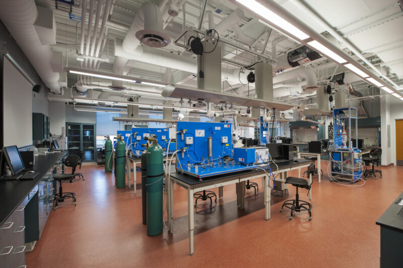 Research lab inside of the Biomedical Engineering Research Building consisting of lab tables, equipment, stools and desk space.