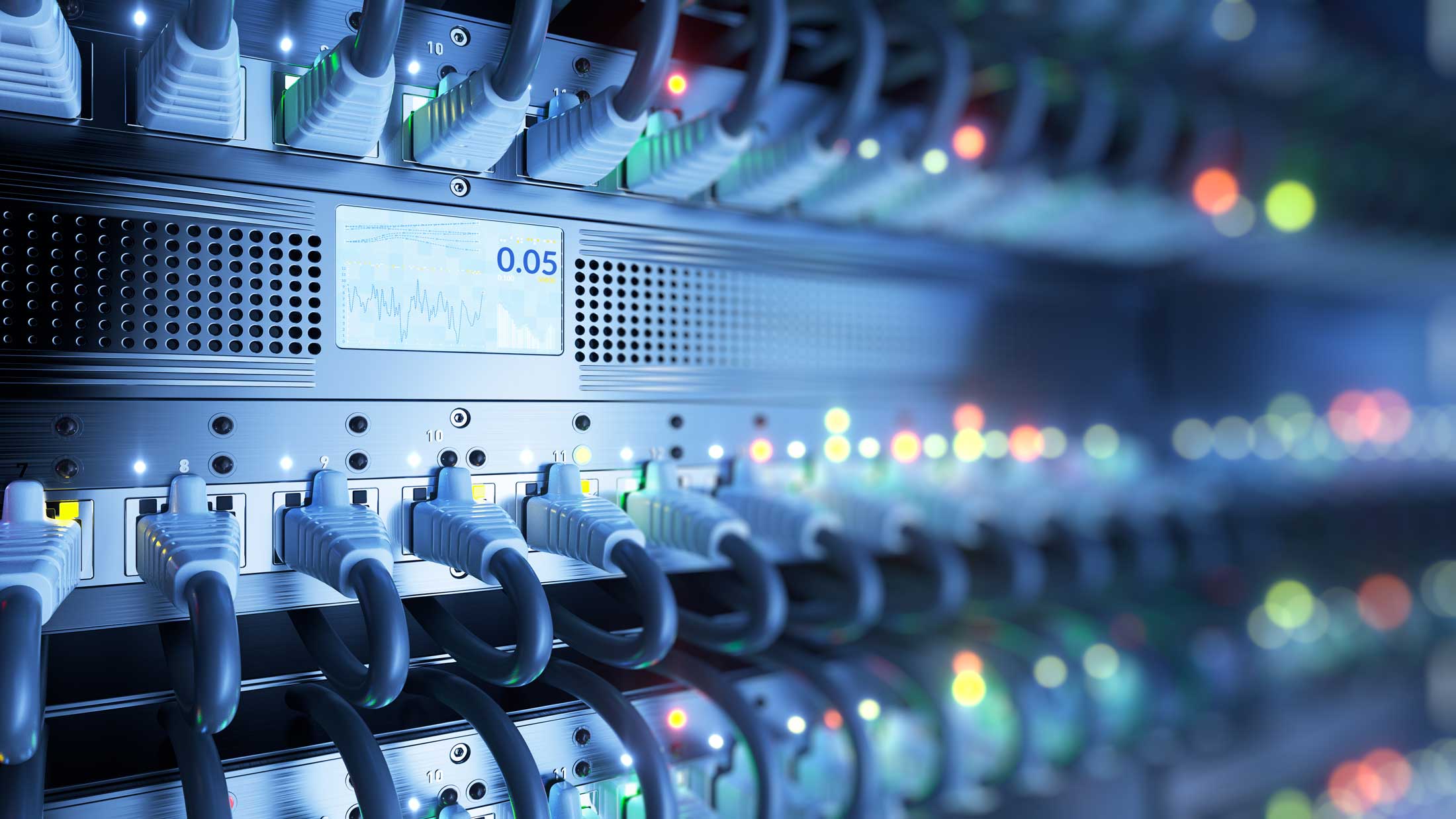 Server box with numerous wires plugged into it and colorful flashing lights.