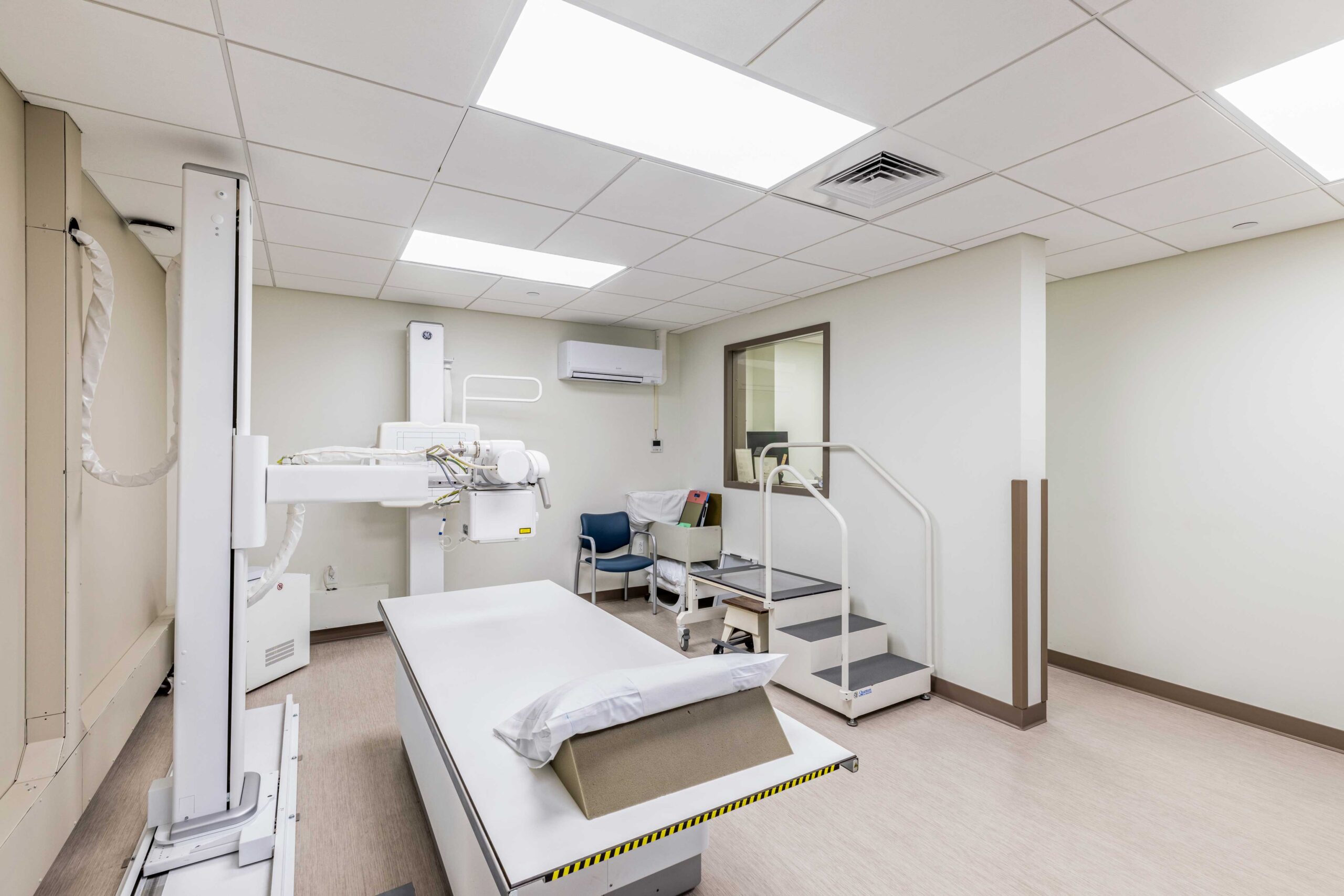 Specialized facility room with advanced equipment and exam bed.
