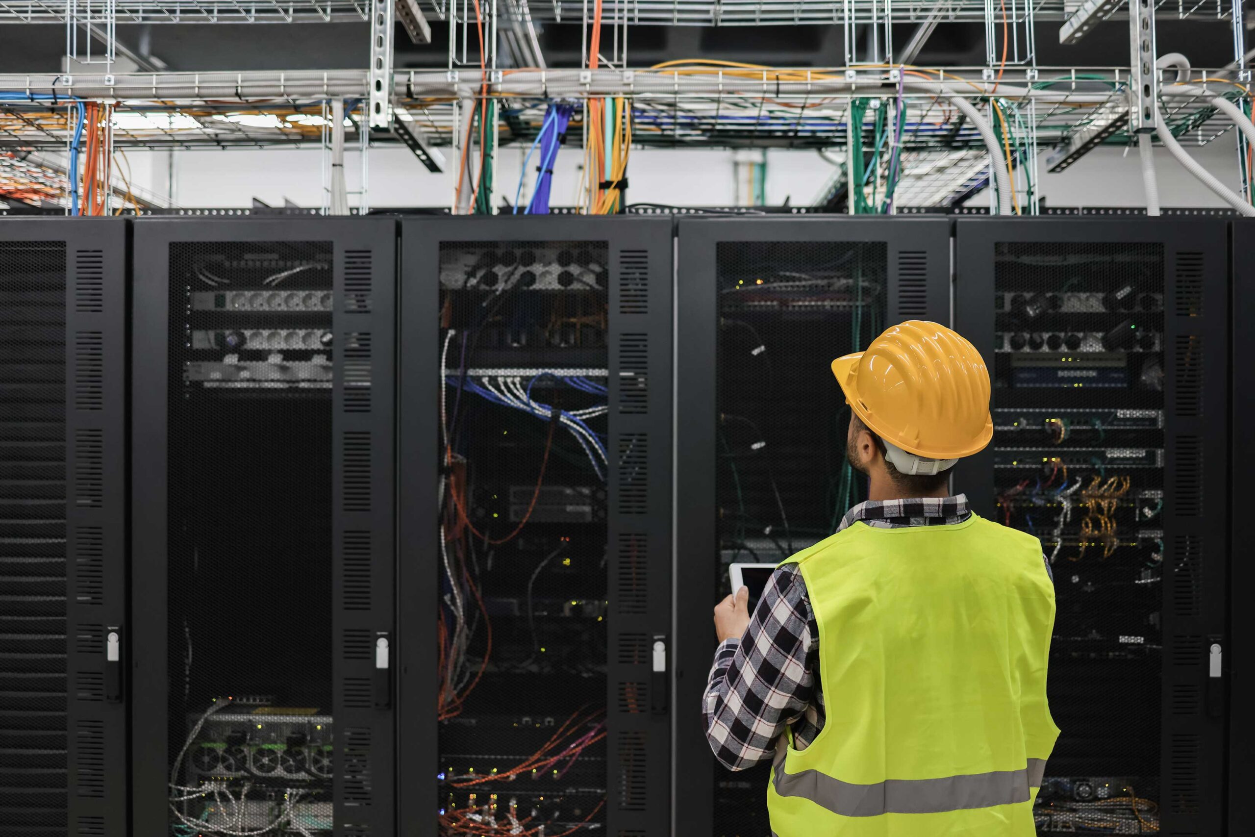 Professional examines data center server room