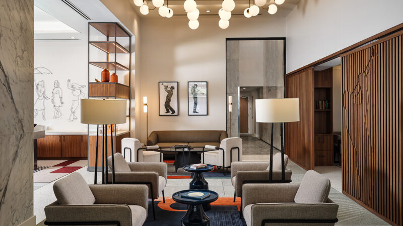 NOLA Hilton Canopy lounge interior showcases modern lighting and warm colored furniture.