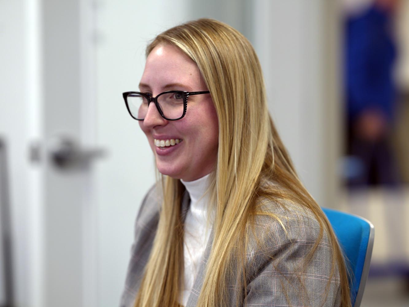 Professional smiles at coworkers