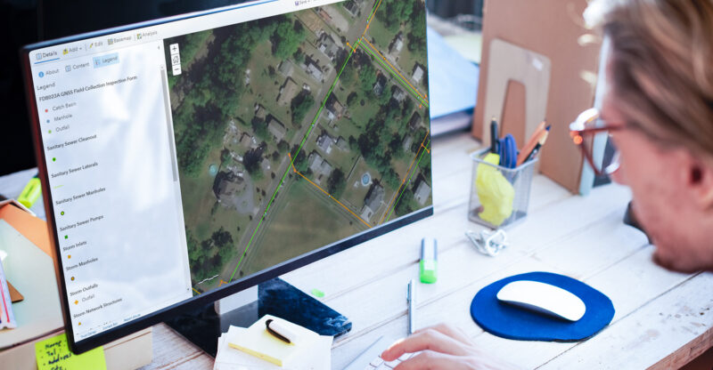 Professional looks at GIS asset management tracking sanitary sewers