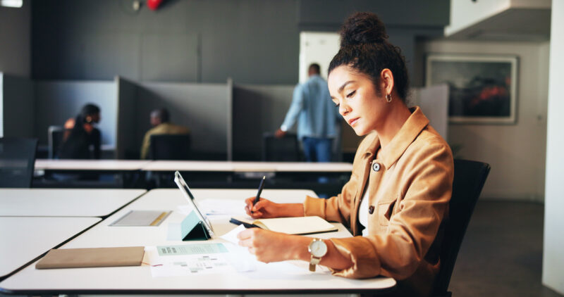 Professional analyzes paperwork and writes responses.