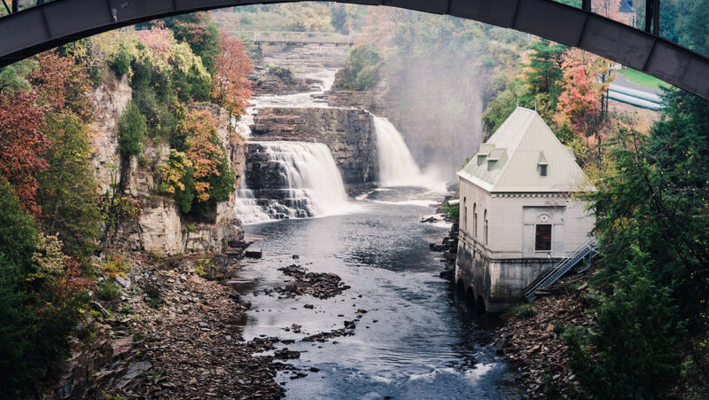 River running by and powering hydropower facility
