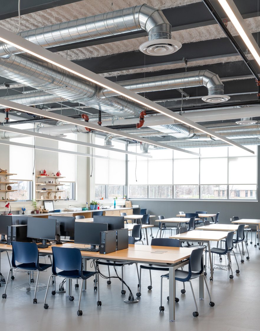 Classroom interior at the Oxford Middle School boasts natural light, communal tables and modern, industrial aesthetics.