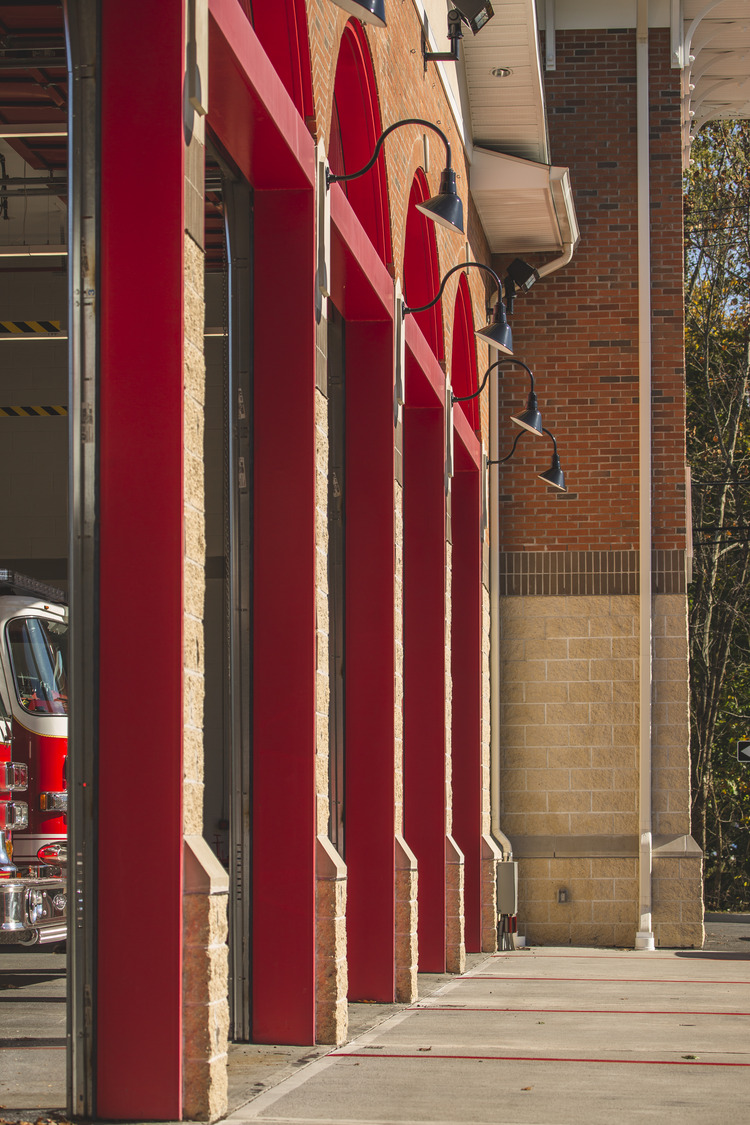 exterior of firehouse with all garage bay doors open