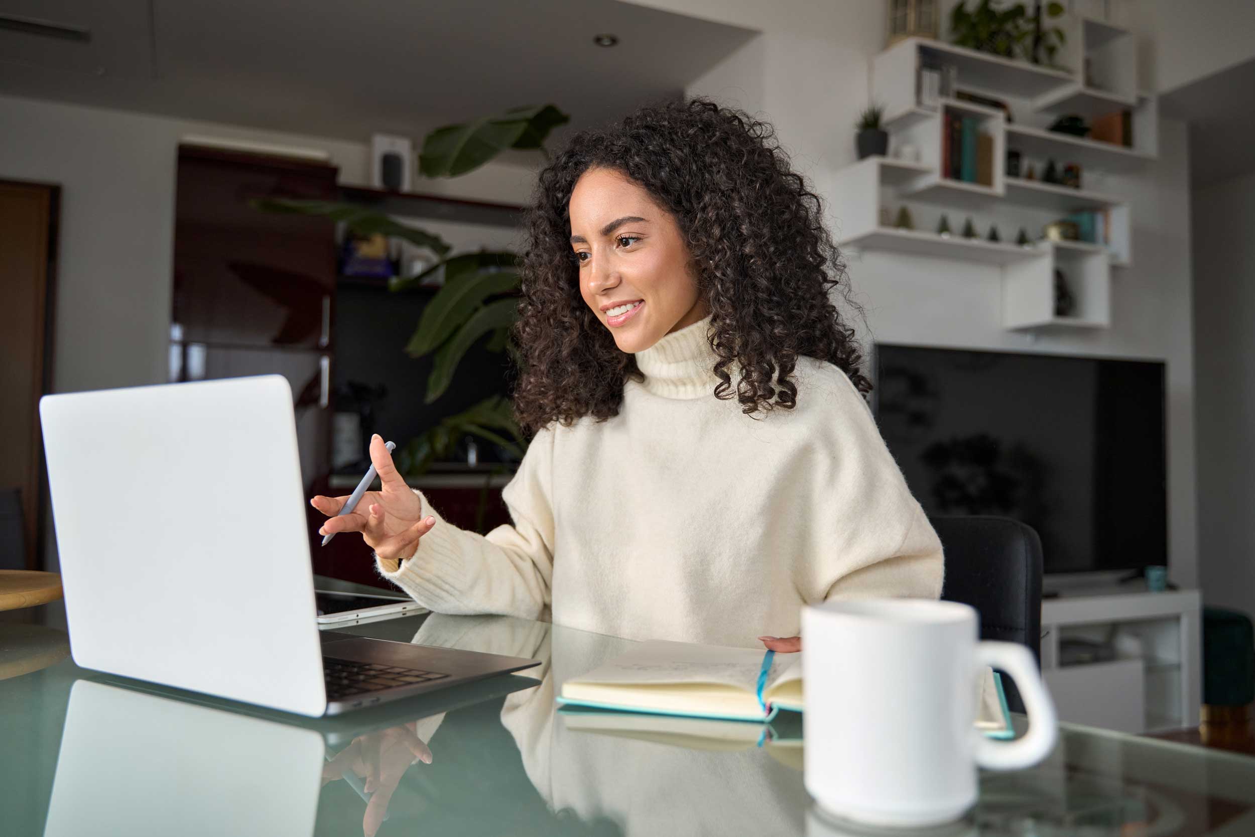 Female student taking a hybrid course for school at home.