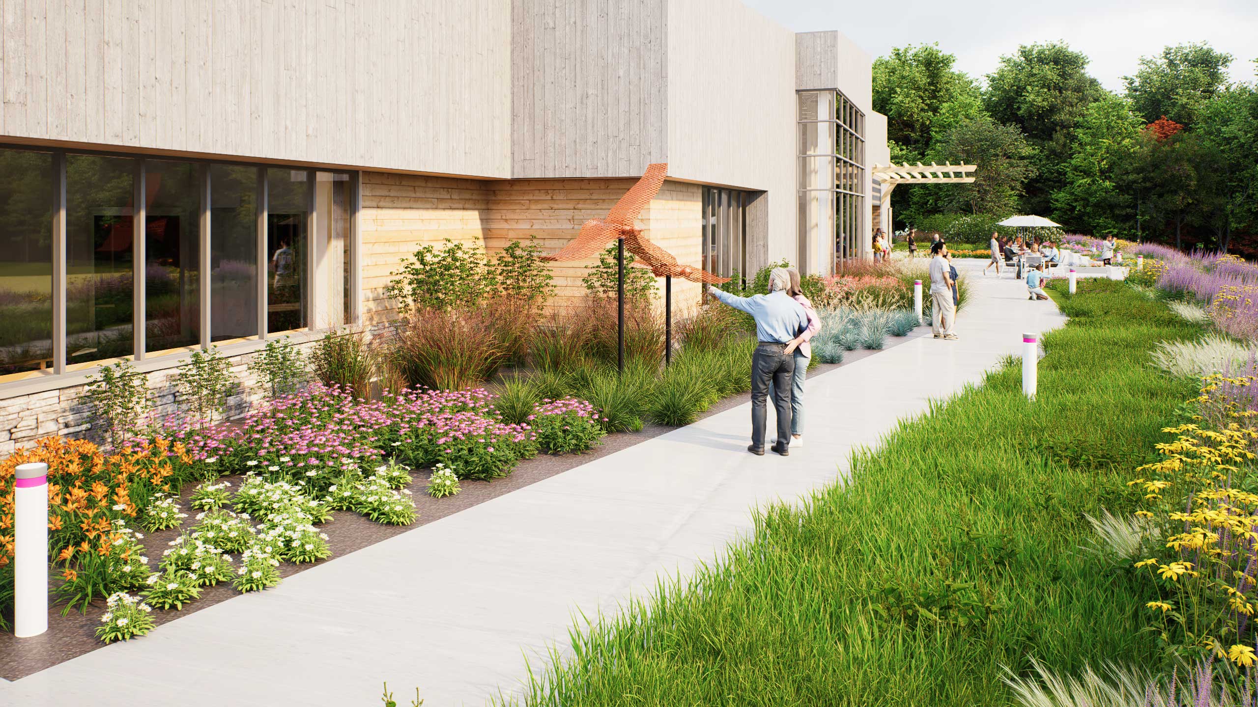 Older couple admiring an interpretive art sculpture made of recycled and local materials on the back walkway of the Saunders Finger Lakes Museum.