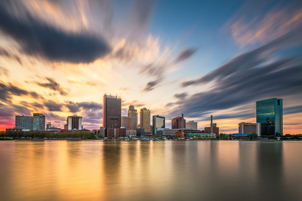 Toledo, Ohio, USA downtown skyline on the Maumee River at dusk.